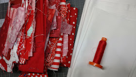 Red fabric scraps for making a quilted Valentine