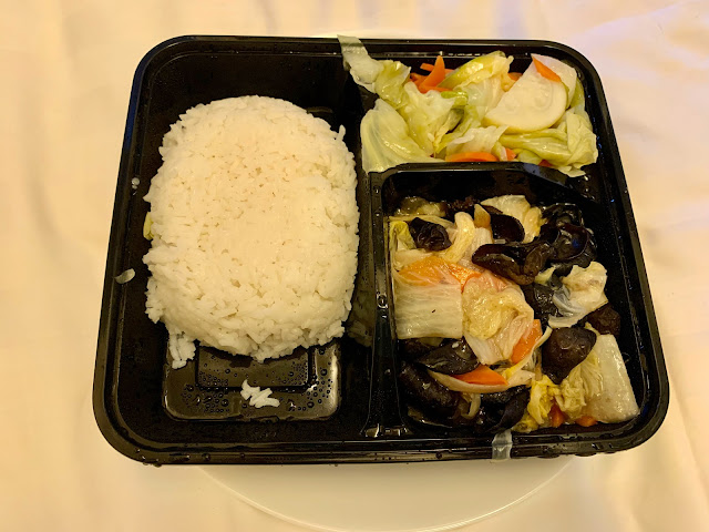 Divided plastic tray of rice and two cabbage dishes