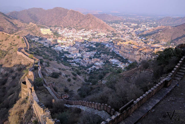 Breathtaking views of the Amber fort and town and the fort passing through the Aravalli mountains as seen from Jaigarh fort