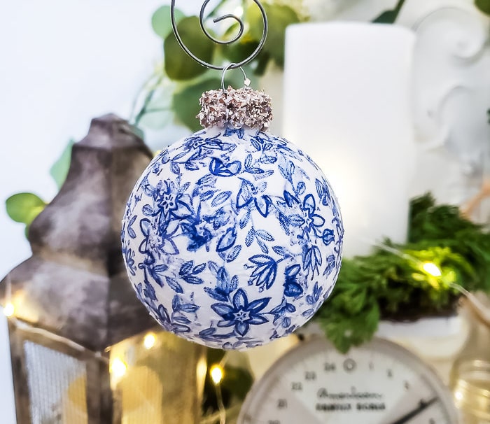 blue and white decoupage ornament with glass glittered top