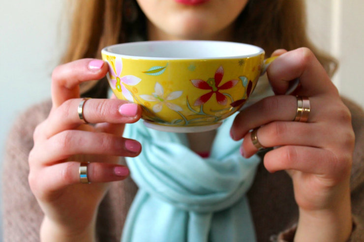 Caramel colored sweater, drinking tea with red lipstick