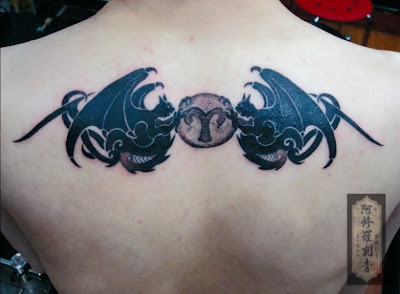 totem tattoo on the back, looks like angel wings