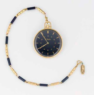 The golden watch with the Egyptian crown and "F" on its back