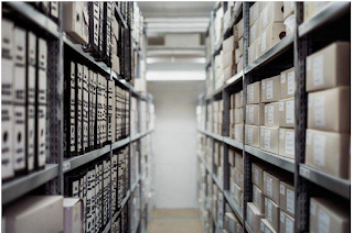 Row of archival materials extending on left and right side.