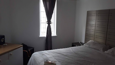 BEDROOM WITH TILED FLOORS AND LARGE WINDOWS