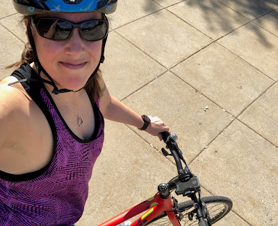 Selfie of Jean in a bike helmet. You can see part of the bike she is sitting on.