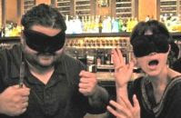 Two blindfolded diners hamming it up.