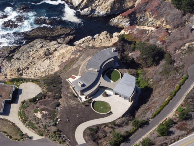 Aerial picture of otter cove residence built on the cliffs above the ocean