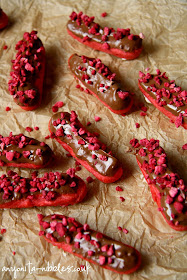 Red velvet eclairs with freeze dried raspberries on parchment from Anyonita-nibbles.co.uk