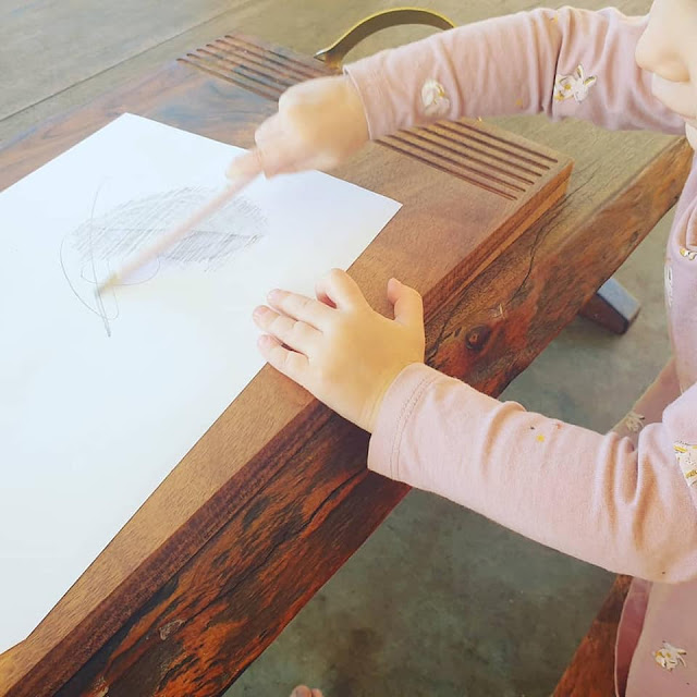 Child doing leaf rubbings