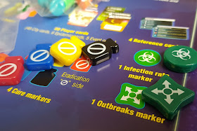 Pandemic Game Review colourful counters disease markers close up photo