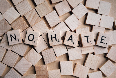 wooden cubes with letters reading "no hate"