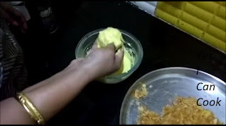 Dip the rounded spheres of Aloo Bonda in Besan as shown and coat them well with Besan.