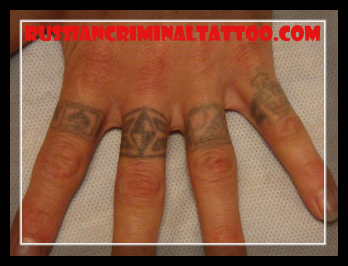 On the index finger Spades tattoo most likely this is thief's suit