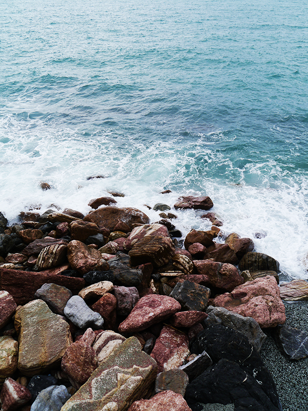Waves crashing into rocks in Monterosso al Mare, Cinque Terre, Italy