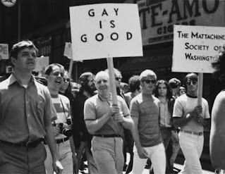 Protesters carrying a "Gay is Good" placard