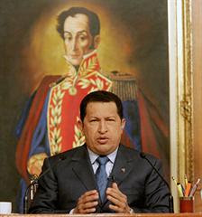 Venezuelan President-for-Life Hugo Chávez posing (again) in front of portrait of Simón Bolívar