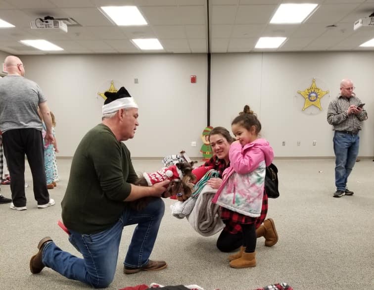 Sheriff giving a little girl a gift