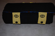 . rolled up with 2 button tabs that I embroidered with the Batman symbol .