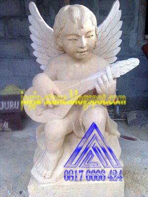 patung angel main gitar