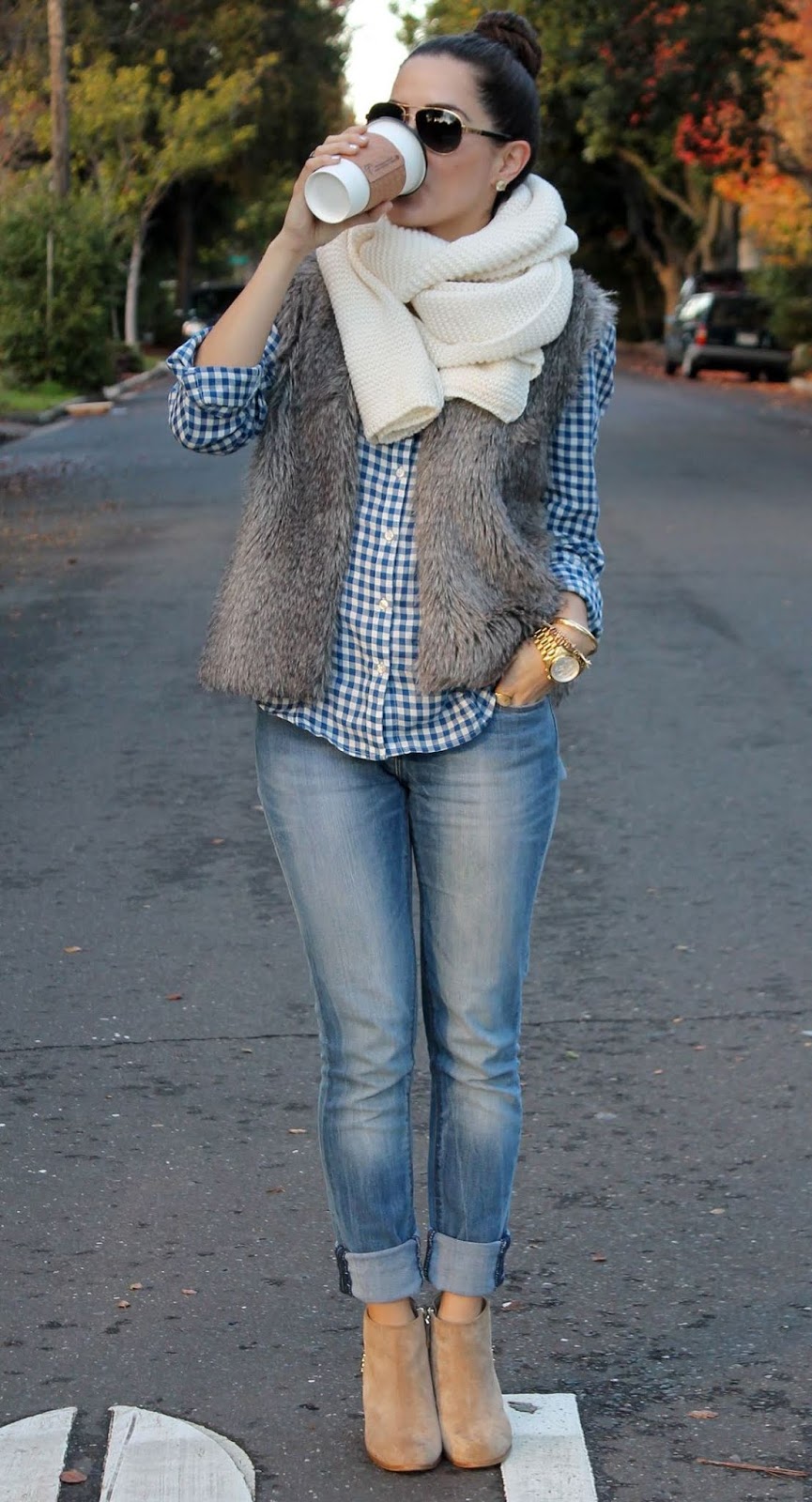 how to style a fur vest : white scarf + plaid shirt + skinny jeans + boots
