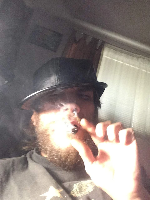 Oregonleatherballs bearded wearing a leather hat and smoking a cannabis