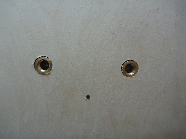 Wall elbows for shower sitting flush with birch plywood lining panel