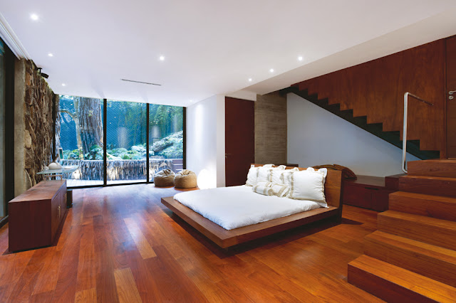 Picture of large modern bedroom with white bed and wooden floors