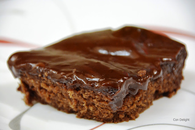 slice of chocolate cake topped with ganache