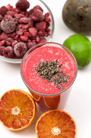 Red smoothie Beet Raspberry orange lime close up