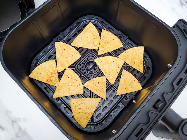 tortillas in air fryer basket before cooking.