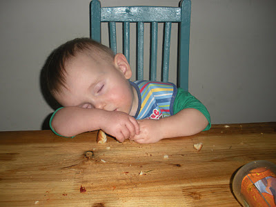 kid eating food and sleeping