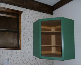 green painted corner wall cabinet