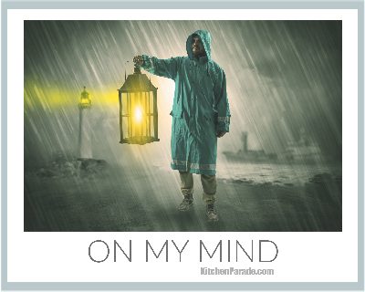 On My Mind ♥ KitchenParade.com, photo of a man standing in rain wearing rain gear and holding a lantern.