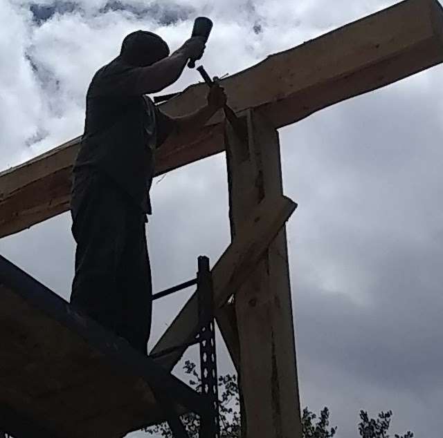 A man building his own log cabin