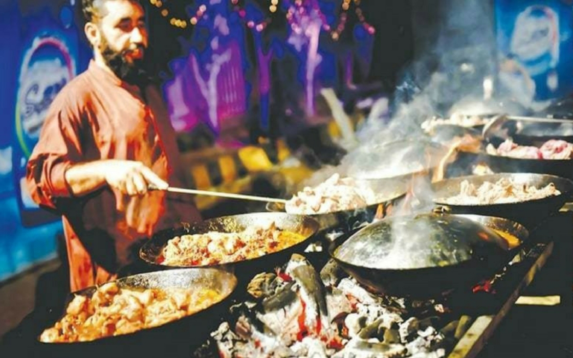 Man frying Chicken Karahi, BBQ meat on Karachi food street
