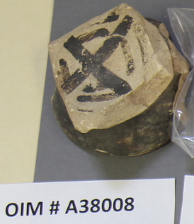 Fragment of a ceramic from Tall-i Bakun, Iran, with a swastika.