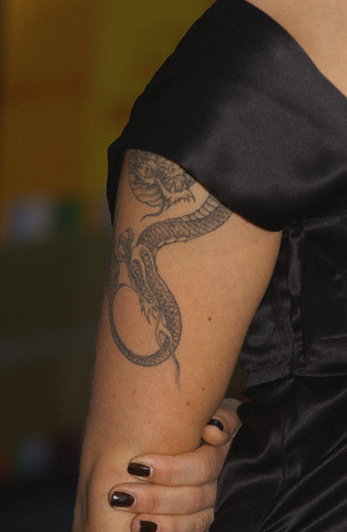 Dragon Tattoo Black dragon tattoo on female's arm