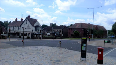 The junction outside Hatfield Station with crossings marked in a large X in the middle all controlled by traffic lights.