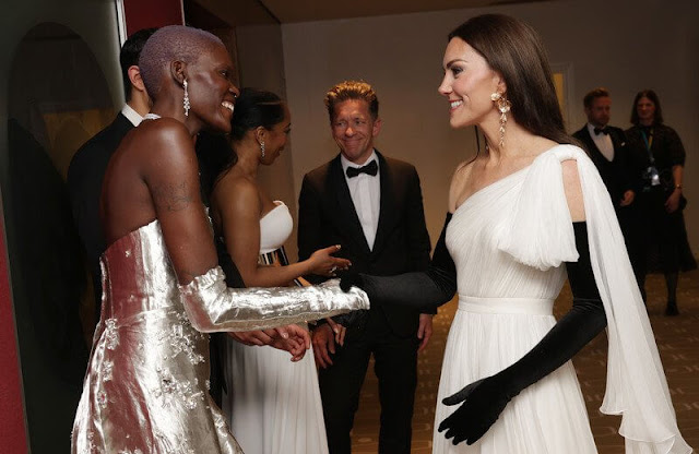 Princess Kate wore a white one-shoulder dress by Alexander McQueen. Cornelia James gloves. Zara floral earrings. Aquazzura