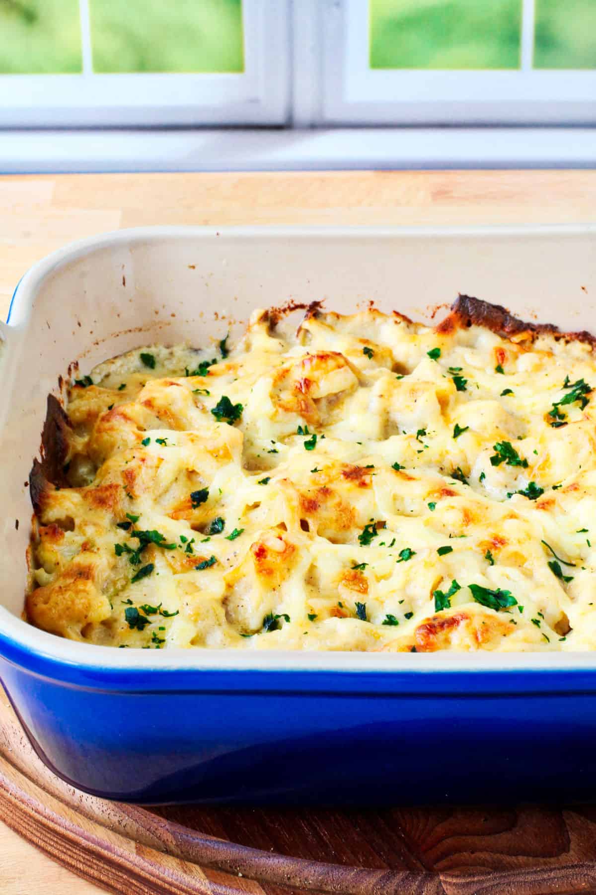 Cauliflower Cheese in a blue casserole dish.