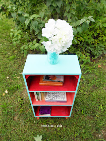 Pretty Turquoise with Coral and Red on a Bookcase Makeover from Denise on a Whim