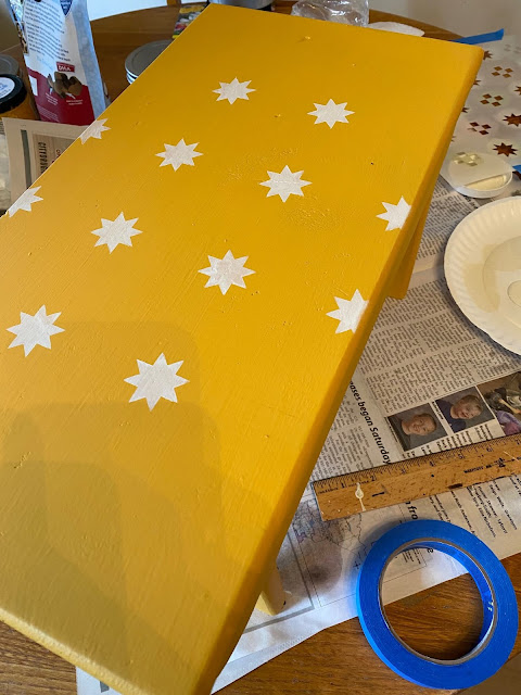 Photo of stenciled stars on a bench top.