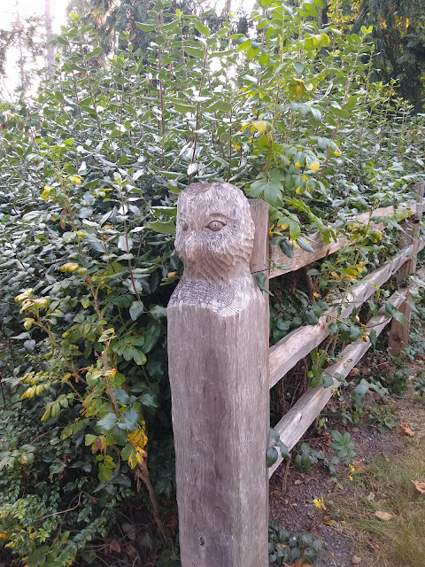 Owl-head carving on the top of a fence post