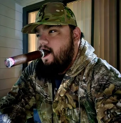 Camo bear smoking a cigar on the front porch
