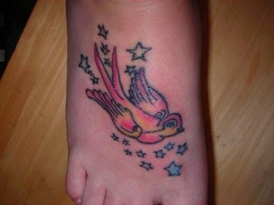 Swallow tattoo and stars on foot