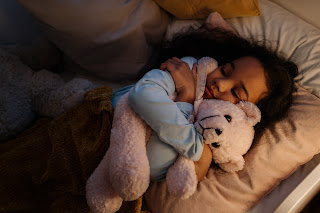 A child sleeping with a rabbit stuffed animal | Best rated chiropractor Ann Arbor