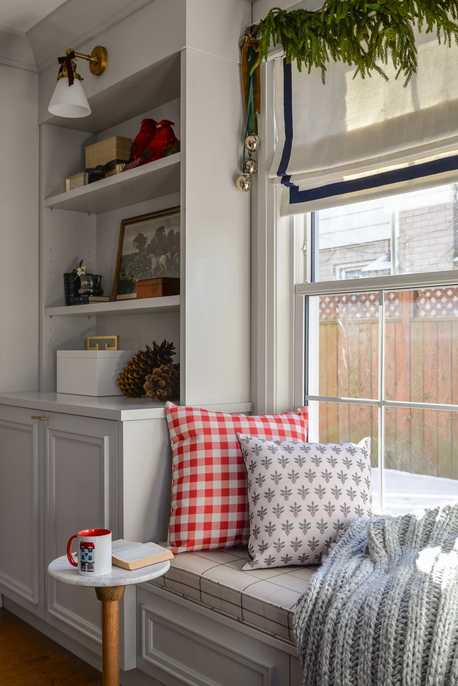 living room christmas decor with plaid pillows, velvet bows, and faux garlands