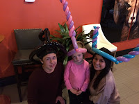 Family wearing balloon hats