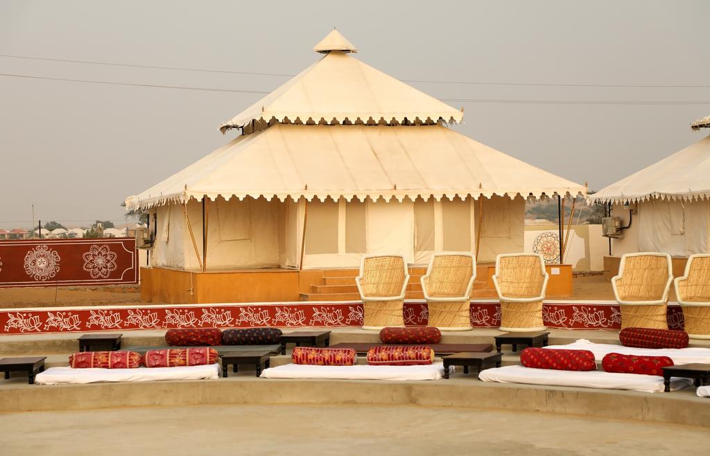 BHAVYA RESORTS JAISALMER - With garden views, Bhavya Resorts is situated in Jaisalmer and has a restaurant, a 24-hour front desk, bar, garden and children's playground. Both WiFi and private parking are accessible at the tented camp free of charge.  Featuring a balcony, each unit is air conditioned and features a dining area and a seating area with a cable flat-screen TV. There is a private bathroom with shower in all units, along with a hairdryer and free toiletries.  Bhavya Resorts offers a continental or buffet breakfast.  Guests can also relax in the shared lounge area.  Kuldhara Village is 39 km from the accommodation. The nearest airport is Jaisalmer, 72 km from Bhavya Resorts, and the property offers a paid airport shuttle service. CALL US ON 8000999660, 9427703236 FOR BEST RATES, JAISALMER TENT, JAISALMER HOTEL, JAISALMER RESORT, JAISALMER FLIGHT PACKAGE, JAISALMER RAILWAY TICKET, JAISALMER HOTEL PACKAGES, JAISALMER CAMEL RIDE, JAISALMER DESERT PACKAGE, JAISALMER TOUR BOOKING, WWW.AKSHARONLINE.COM, WWW.AKSHARONLINE.IN